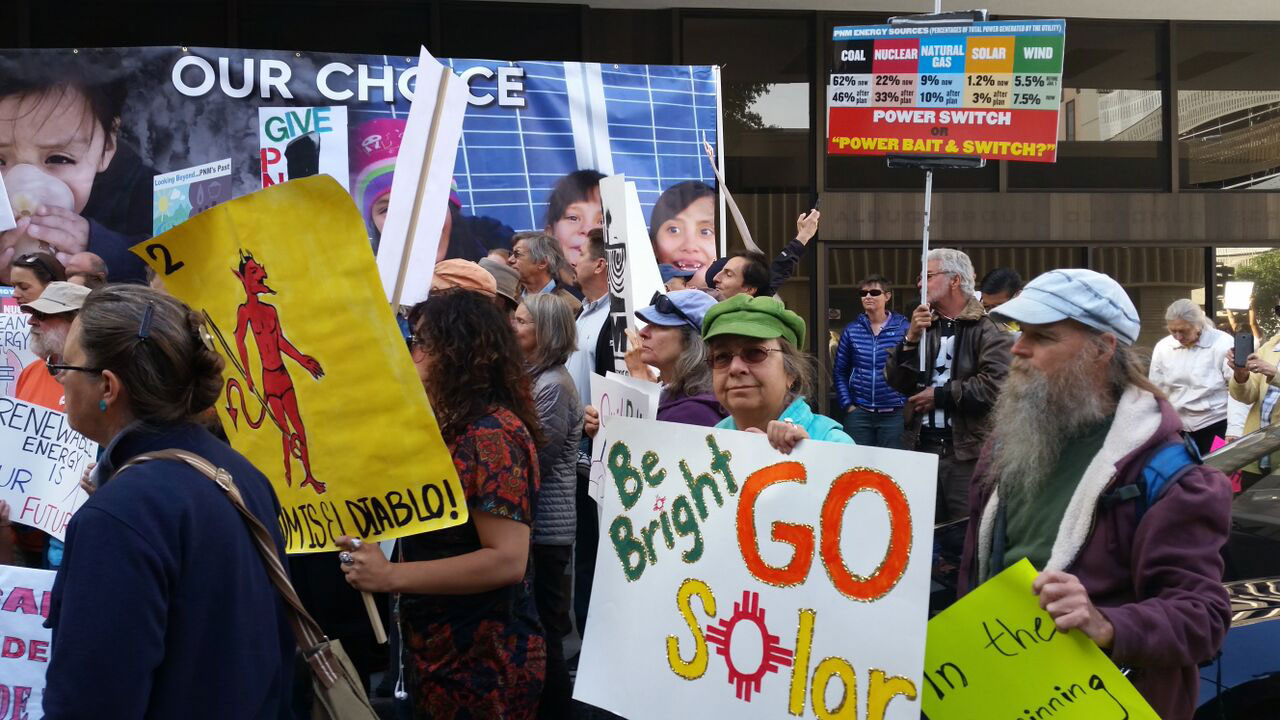 Clean-energy activists outside PNM's Albuquerque headquarters