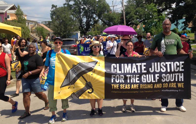 Sierra Club leaders carry Climate Justice banner in Second Line parade from the Lower 9th Ward to the Hunter's Field rally on August 29.