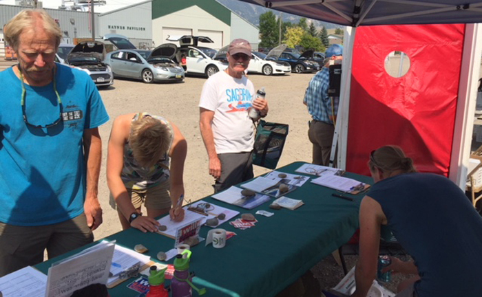 Sierra Club table with electric vehicles in background at the 2018 Montana Clean Energy fair in Bozeman