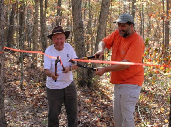 Bob Gestel and Paul Stupperich cutting the ribbon on a new section of Ozark Trail.