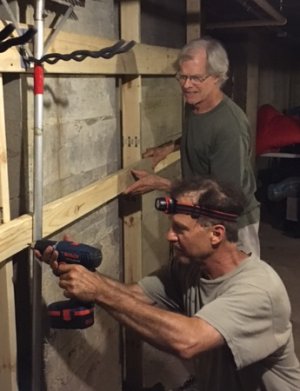 Volunteers installing a tool rack