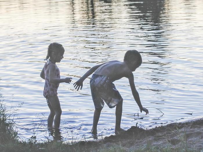 photo of children playing on a lakeshore