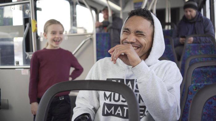 photo of man and girl on a bus, laughing