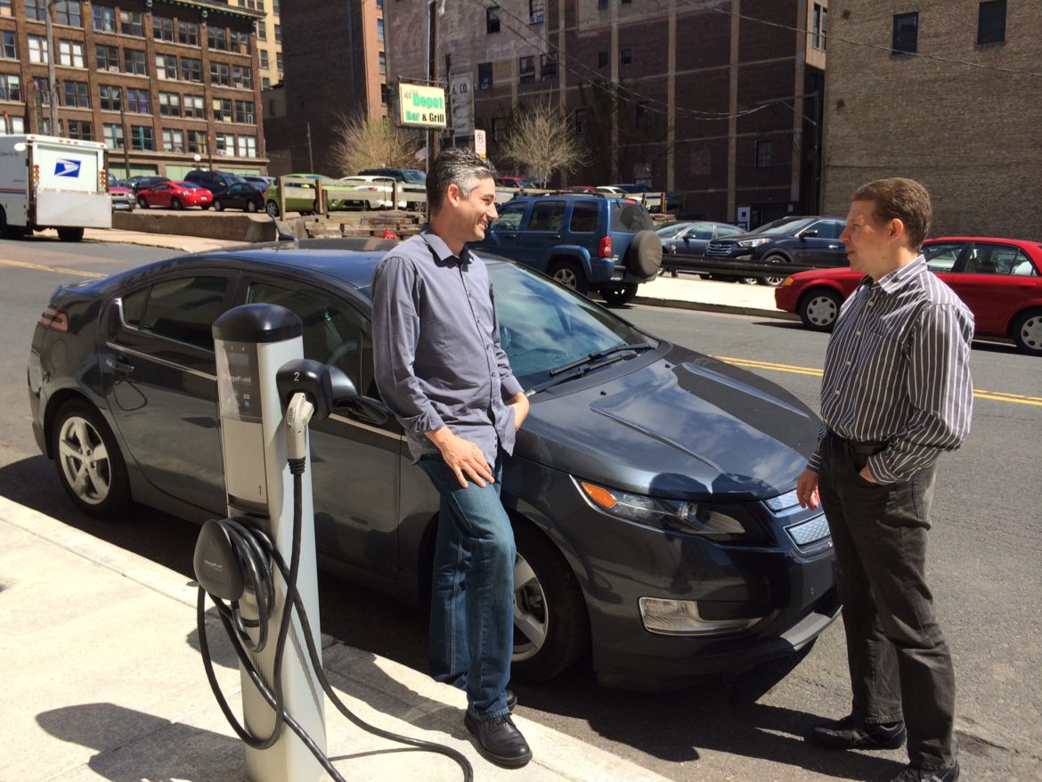 photo of people by an EV charger on the street