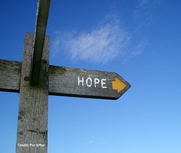 Wooden signpost against a blue sky, pointing to the town of Hope