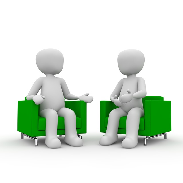 Two generic cartoon characters sitting in green chairs 