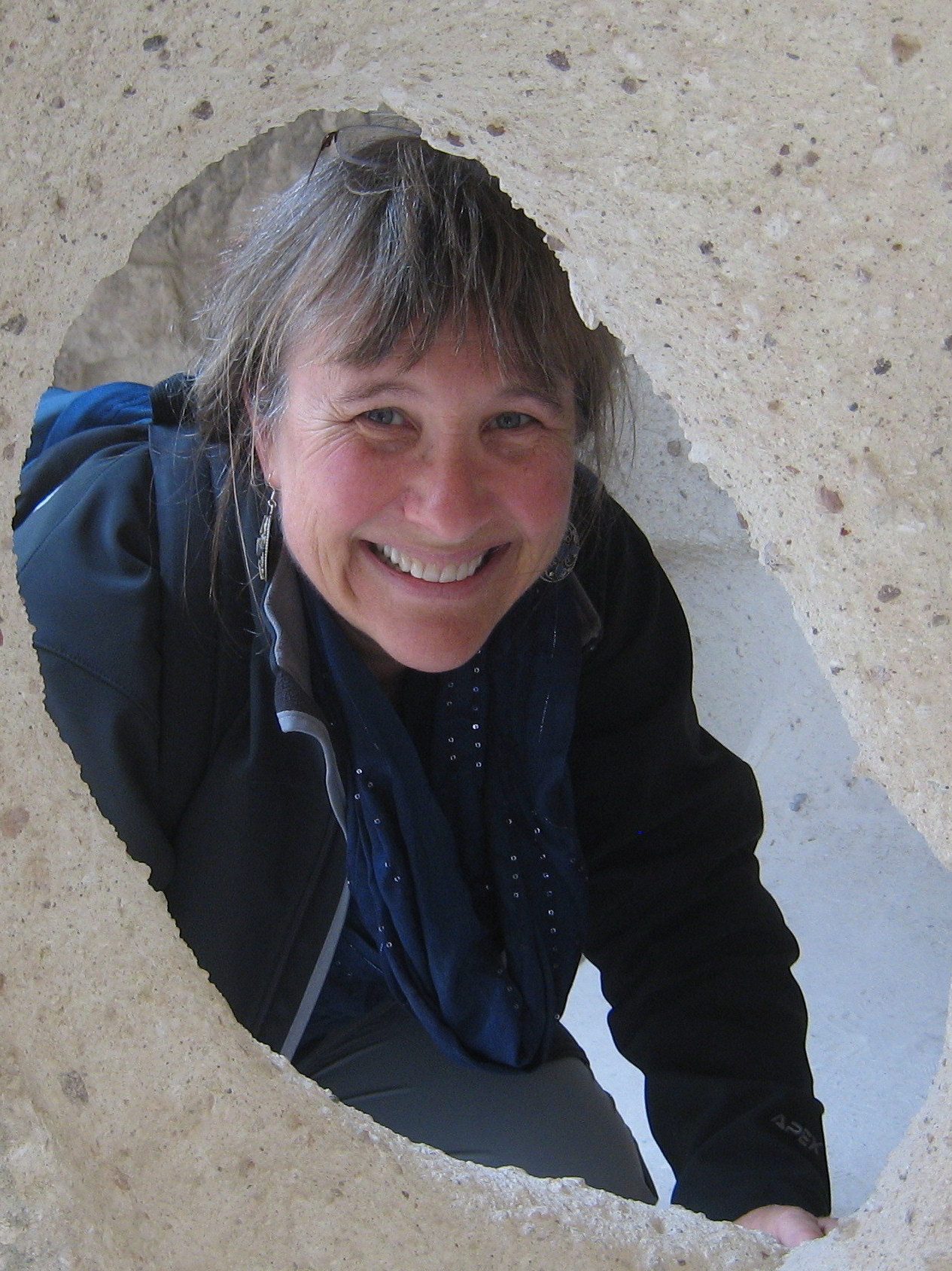 Image of Martha Ainsworth peeking through a cave