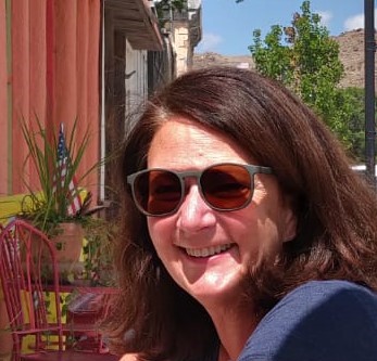 Image of Susan Schorr wearing sunglasses and smiling