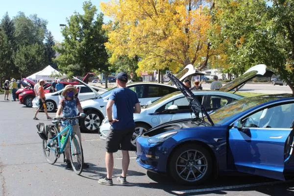 People looking at EVs at a NDEW event. Photo by 4CORE