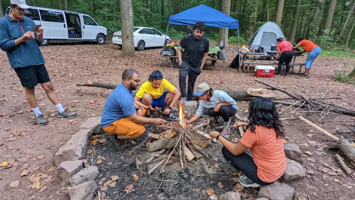 Participants at a September 2022 joint outing from the Sierra Club and Latino Outdoors Philadelphia chapters learn to start a campfire.