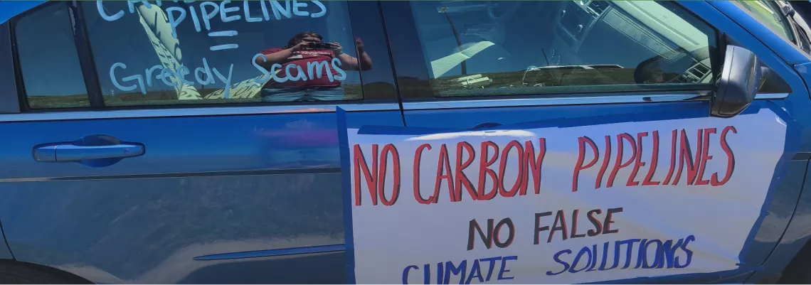 Photo of "No Carbon Pipelines" sign on the side of a car. Credit: Iowa Sierra Club