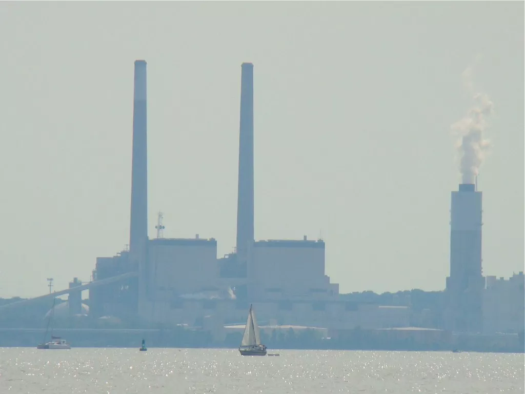 An image of the Brandon Shores coal plant's smoke stacks with a boat in the foreground
