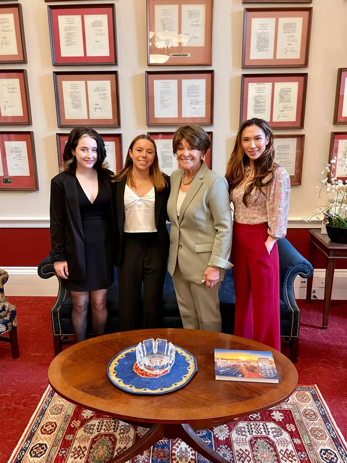 Four people standing in a congressperson's office