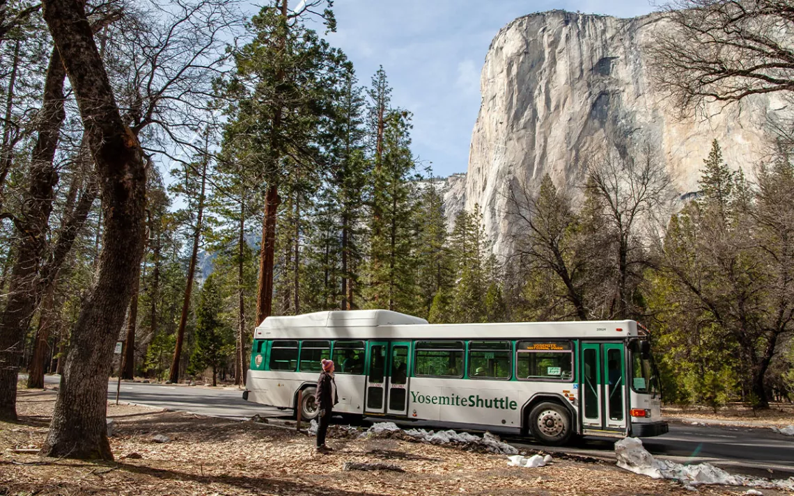 A Yosemite shuttle bus drops off passengers at the Cathedral Beach stop in Yosemite Valley.
