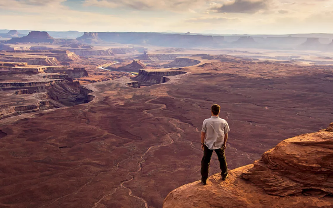A man enjoys the view near Green River Overlook in Canyonlands National Park, Utah. 