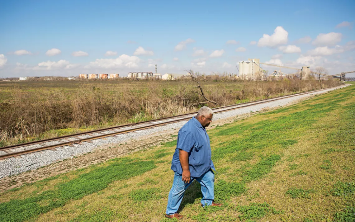 Wilkey Declouet walks by the levee near the proposed RAM coal terminal site, about a half mile away from Ironton, Louisiana.