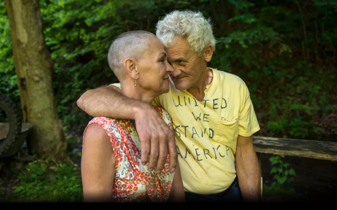 Donna and Charlie Branham at their Lenore, West Virginia home. "It's a hard decision to take your hair off," Donna said. "But it's not as hard as watching them destroy my land, watching them destroy my children's future." | Ami Vitale/Panos Pictures