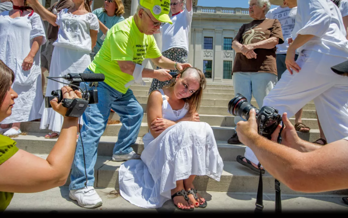 Paula Swearengin gets her head shorn by the late Larry Gibson, founder of the Keeper of the Mountains Foundation. On Memorial Day 2012, more than a dozen women assembled on the steps of the West Virginia State Capitol in Charleston to have their heads sha