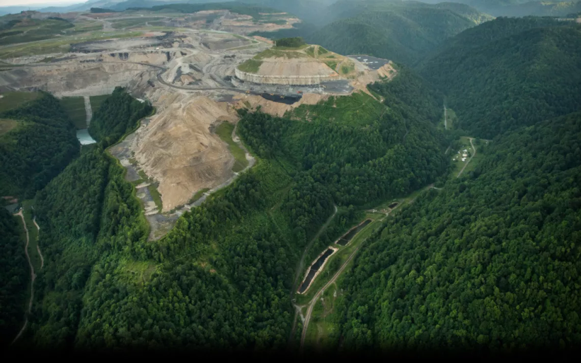 An aerial view of the mountaintop-removal mine that looms above the Richmond property. The home where Roger and Quinnie Richmond is shown at right. "Sometimes it gets lonely now, a little bit," Roger said. "Momma will be sitting on the couch and she'll sa