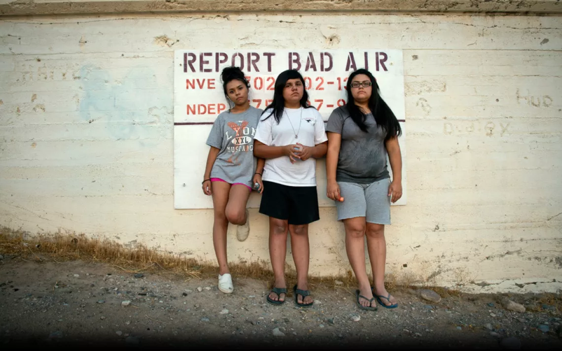 Sisters Aaliyah, Ayona, and Zayda Hernandez near their home on the Moapa Band of Paiutes Reservation, about an hour north of Las Vegas. Since 1965, coal ash from the nearby Reid Gardner Generating station has been dumped into uncovered ''ponds'' less than