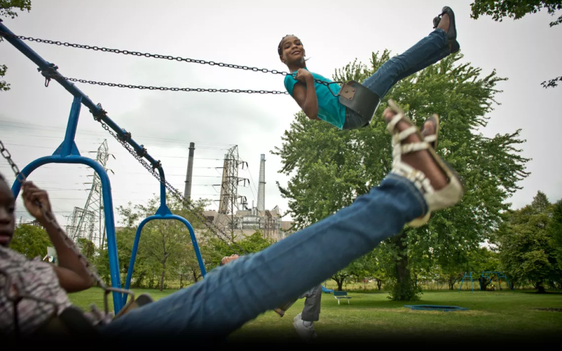 About a mile from her River Rouge, Michigan, home, Nikeya Aaron, 9, enjoys a moment of weightlessness in Belanger Park, which is sandwiched between a coal-fired power plant and a massive steel mill. River Rouge residents also deal with emissions from a ne