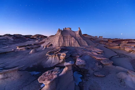 Wandering among the alien rock formations of New Mexico's Bisti/De-Na-Zin Wilderness Area, visitors often lose all sense of scale. This spire, known as a hoodoo, is barely six feet tall.