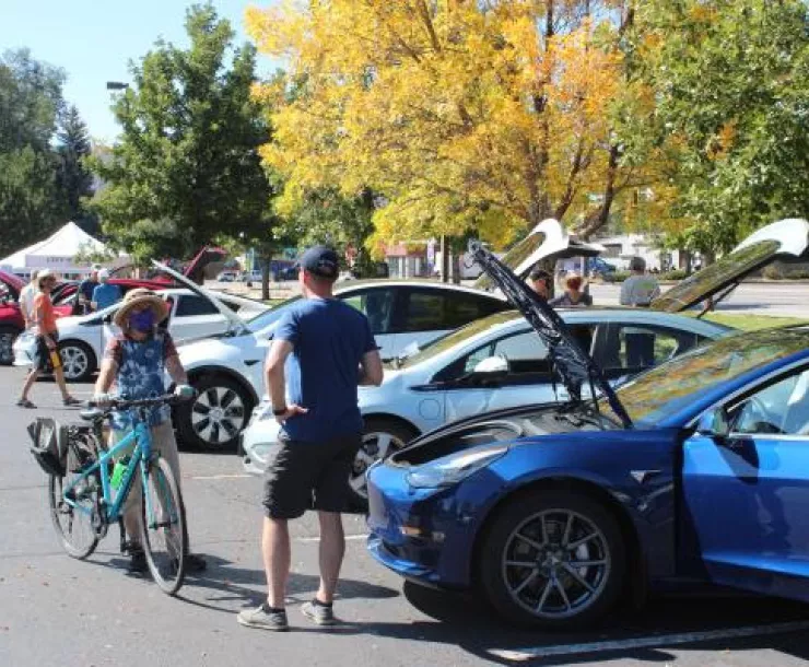 People looking at EVs at a NDEW event. Photo by 4CORE