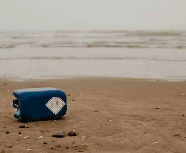Trash labeled "toxic" on a shoreline.