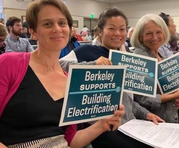 Supporters holding signs that read "Berkeley supports building electrification."