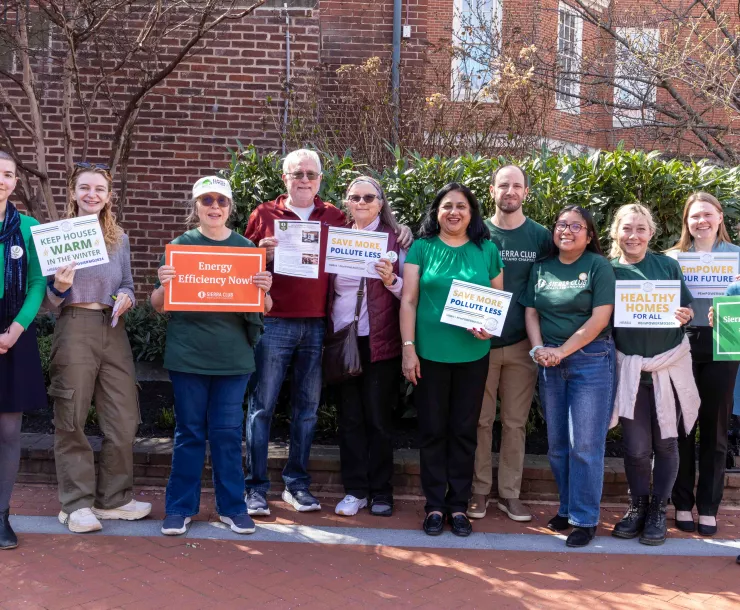 Sierra Club Volunteers and Staff in Annapolis on a sunny day, holding signs supporting EmPOWER.