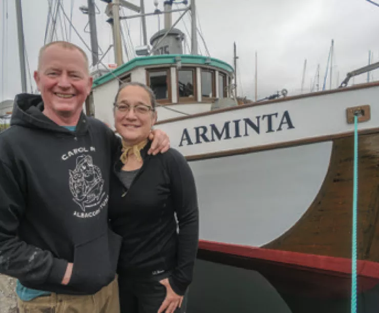 Amy-Grondin-and-husband-with-fishing-boat-June-2018.png