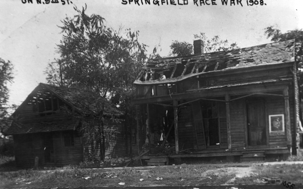 A burned building with the words "Springfield Race War 1908" above it.