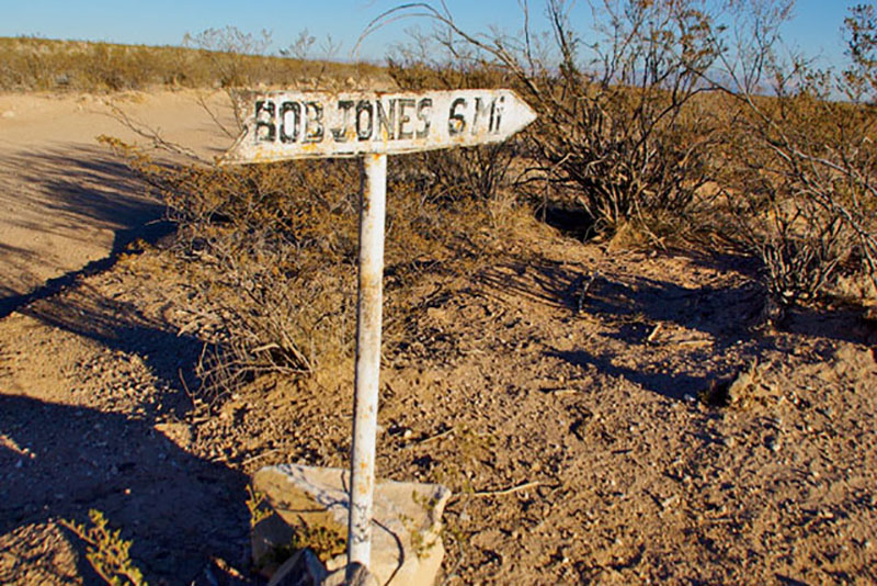 A homemade sign points to an Otero Mesa ranch. | Peter Frick-Wright