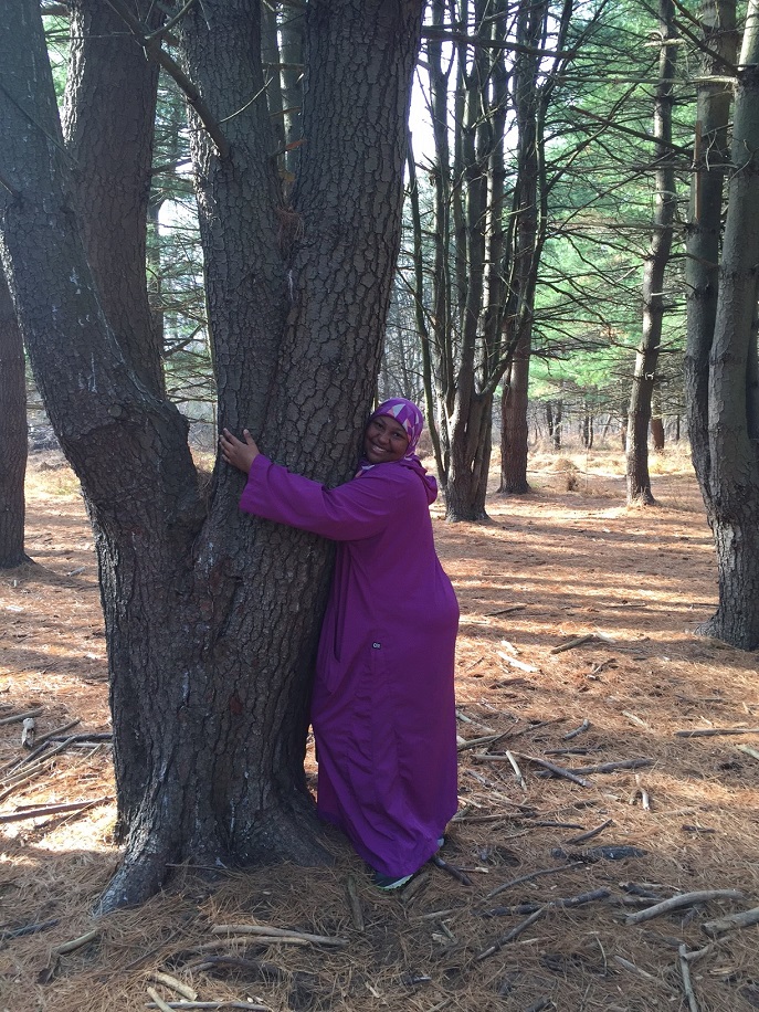 Philadelphia ICO participant shows her love for nature by hugging a tree.