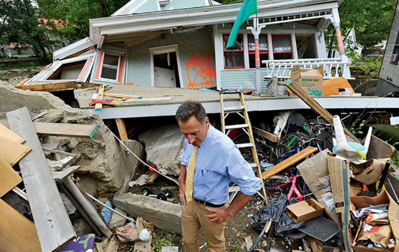 Governor Shumlin surveys a damaged house after Tropical Storm Irene ravaged the state last August. | Photo by Glenn Russell/Burlington Free Press