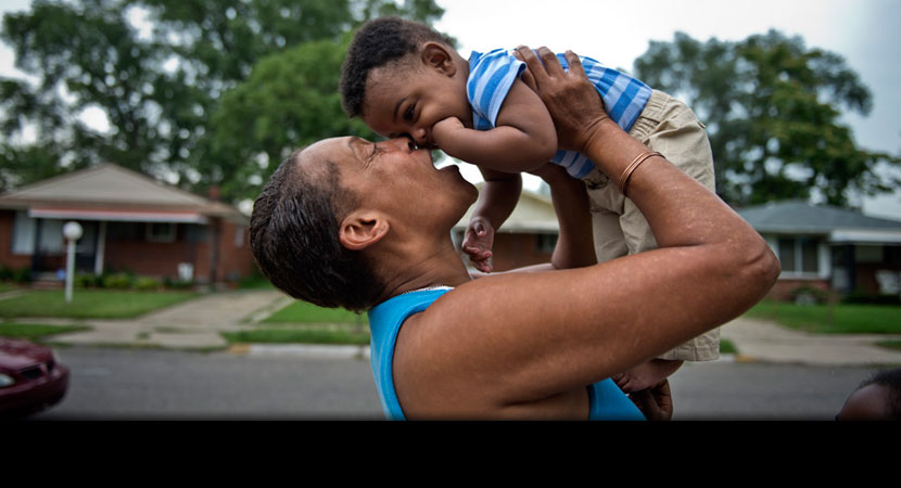 Outside her house in River Rouge, Michigan, Siobhan Washington holds grandson Anthony Johnson, who has asthma.
