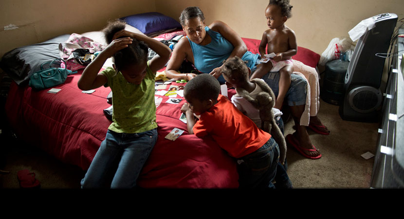 Siobhan Washington plays with her grandchildren in her bedroom.