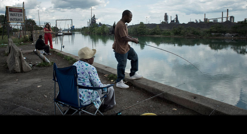 Kevin Morris of Detroit fishes with his mother-in-law, Mary Lee. He eats only predatory fish, which are migratory. Health advocates routinely pass out flyers along the river warning that certain kinds of fish shouldn't be eaten because they might be conta