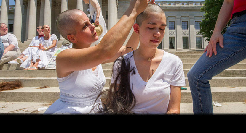 On the steps of the West Virginia State Capitol, Paula Swearengin shears Tori Wong of Virginia. | Ami Vitale/Panos Pictures