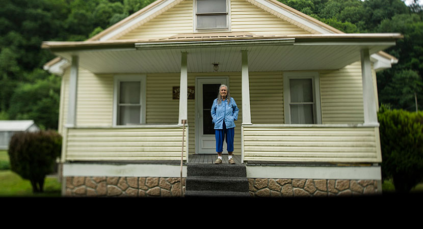 Quinnie Richmond in front of the home where she now lives with her son, Roger. "I don't think the community will ever be like what it used to be," Roger said. "All the houses that used to be here was built by people that lived in 'em." | Ami Vitale/Panos 