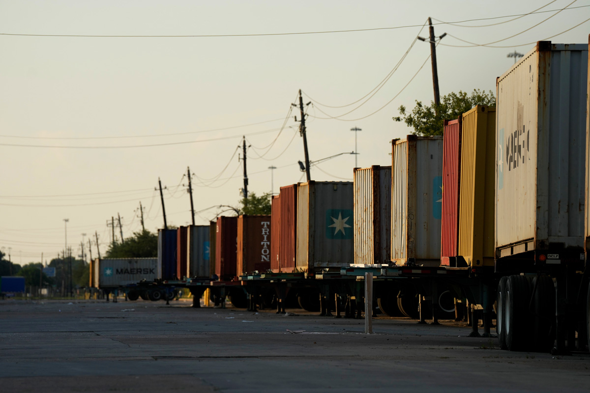 Row of parked trailers stretching into distance.