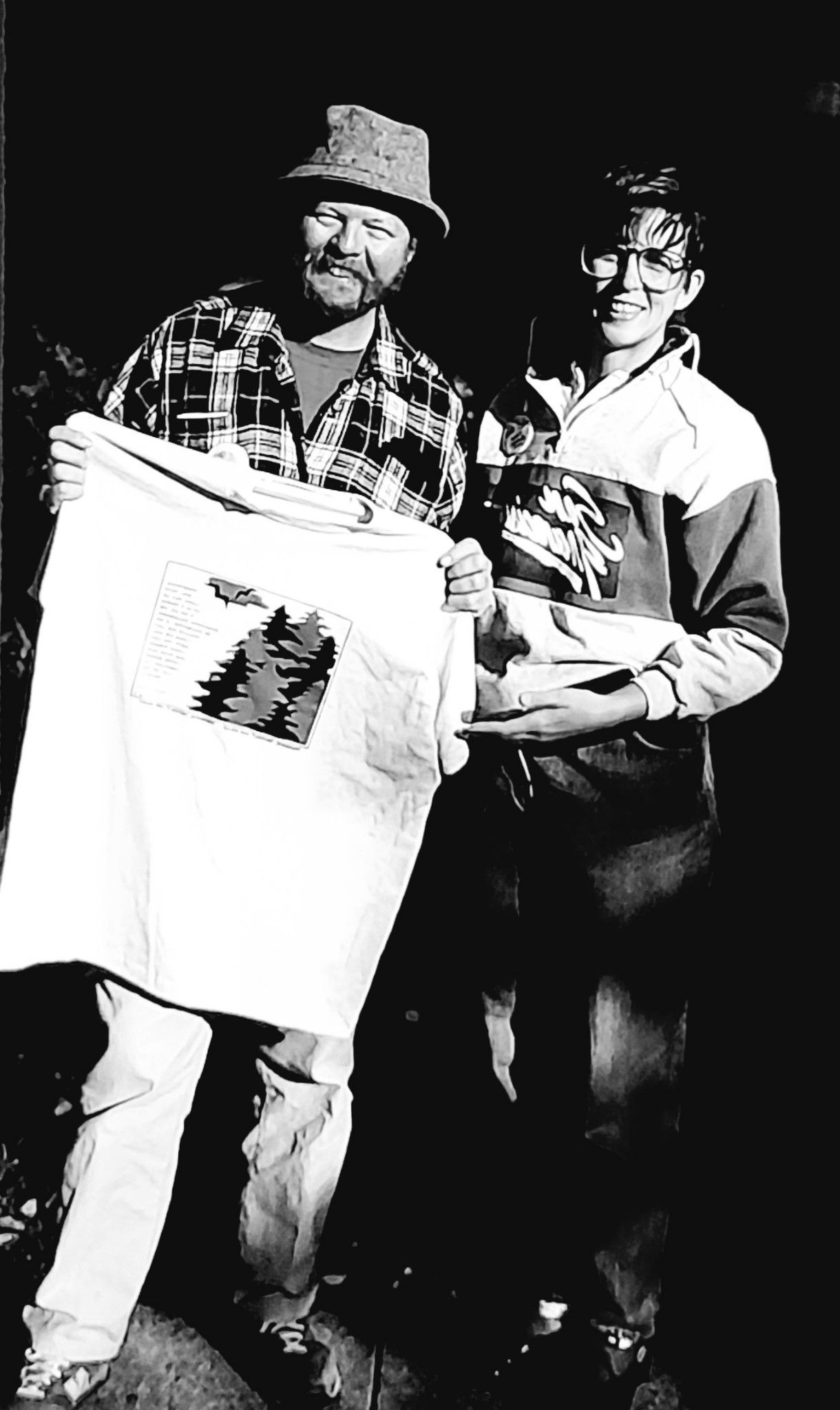 Photo of Dave Foreman receiving T-Shirt from Carol Graham Barnes