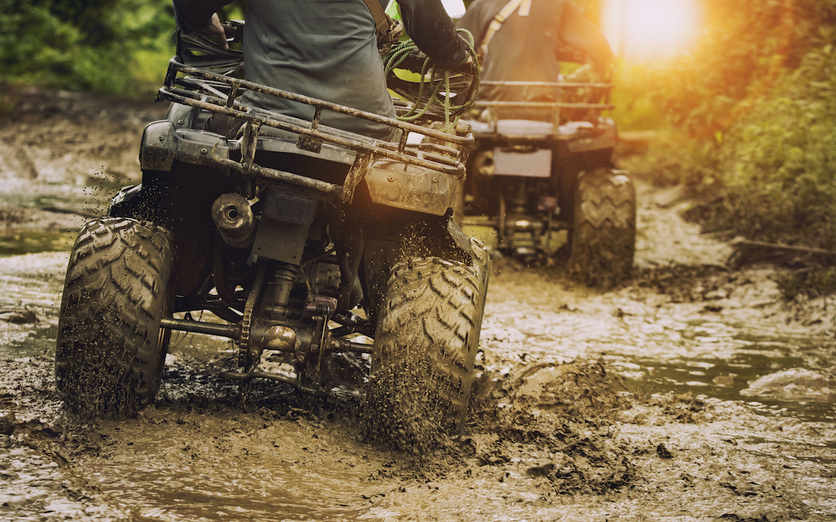 Photo of ATVs crossing a muddy creek. Photo by suriya silsaksom/iStock