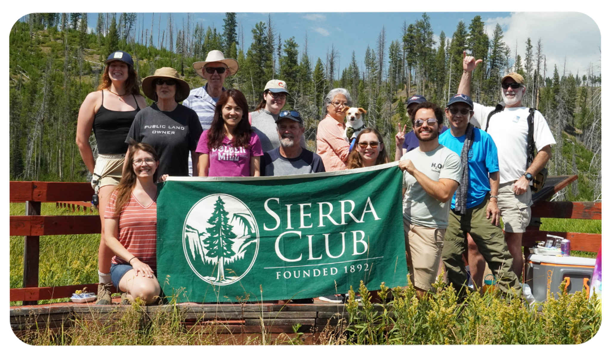 group of adults outdoors holding a banner that says sierra club