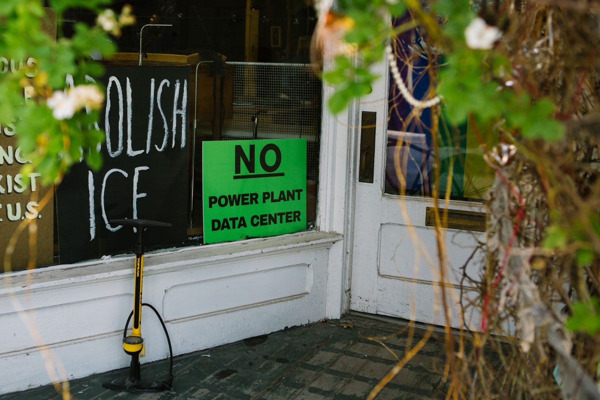 Signs opposing the power plant appear throughout Thomas and Davis.