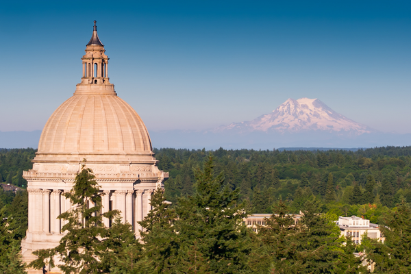 the top of Washington state's capitol dome with Mt Rainier in the background