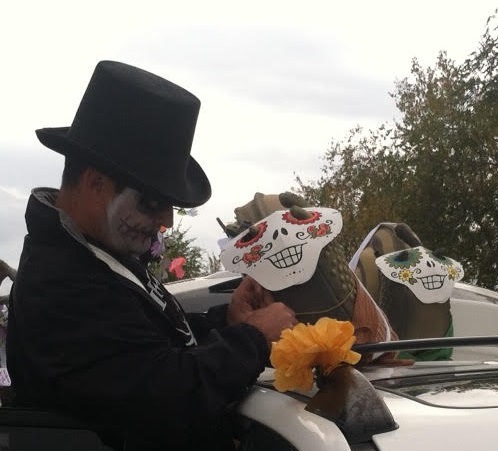 Man Adjusts calavera mask on snail