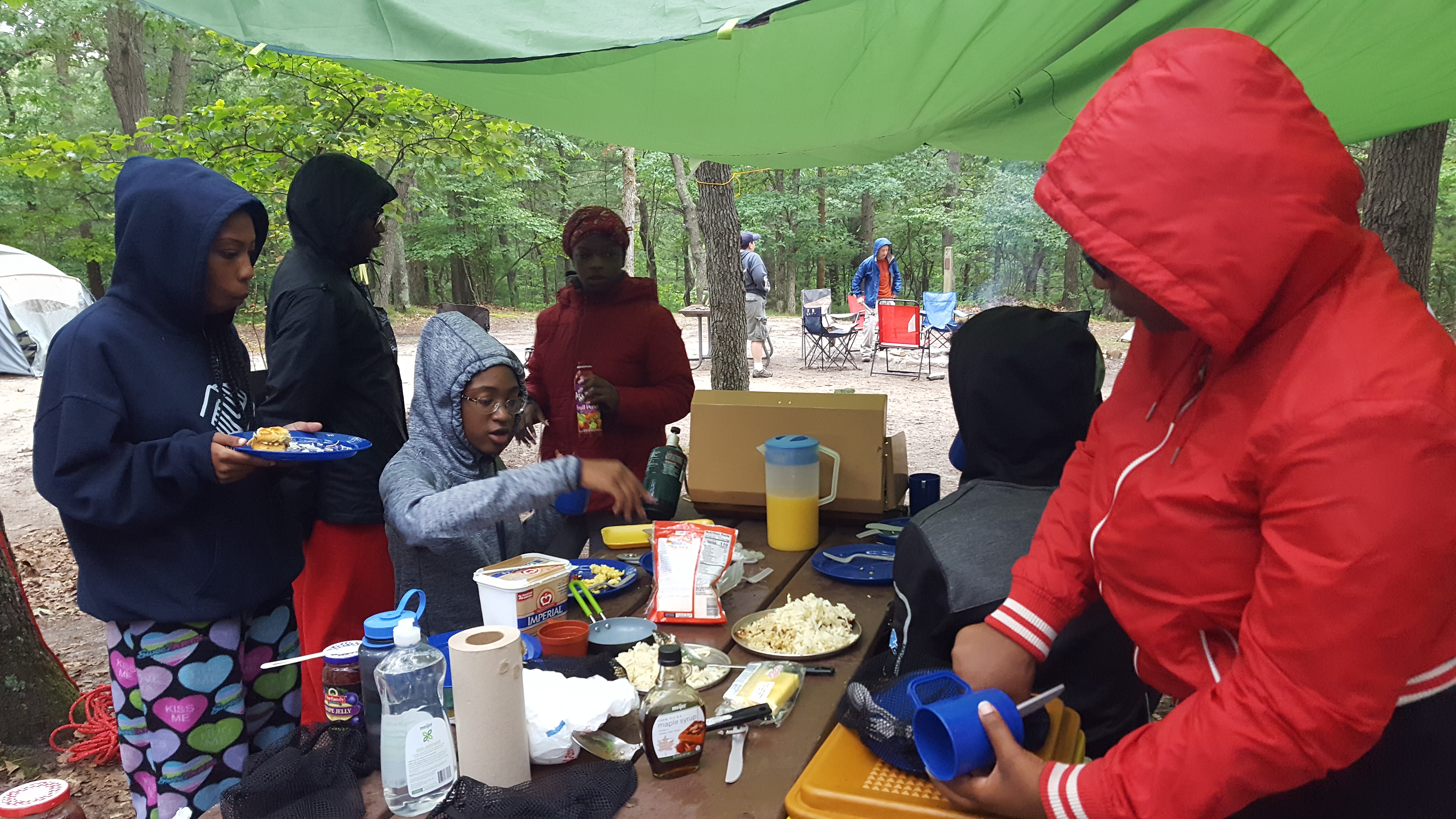 Detroit ICO participants make breakfast at their campsite.