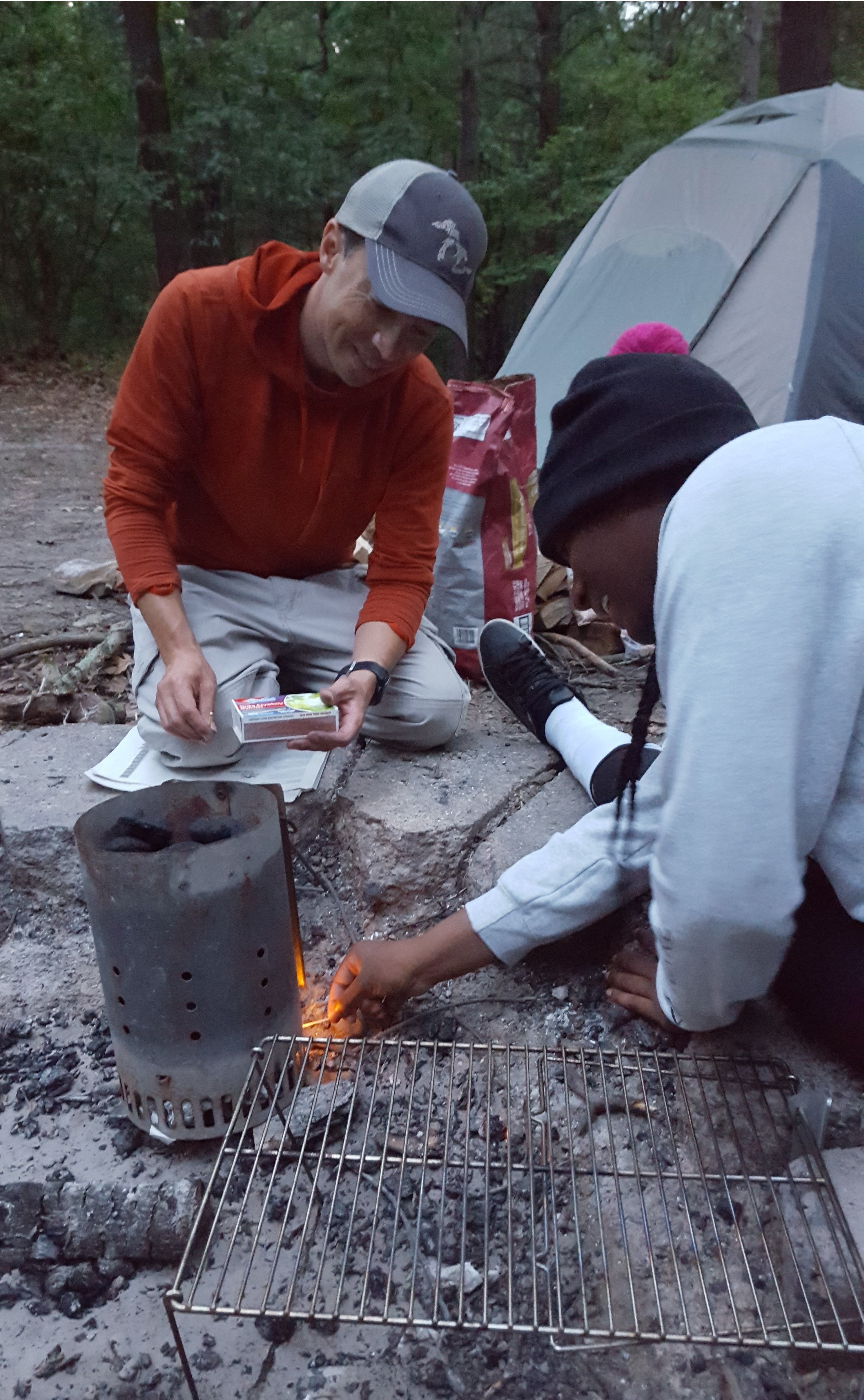 Garrett Dempsey and Andreya Thomas set up the campfire before dinner.