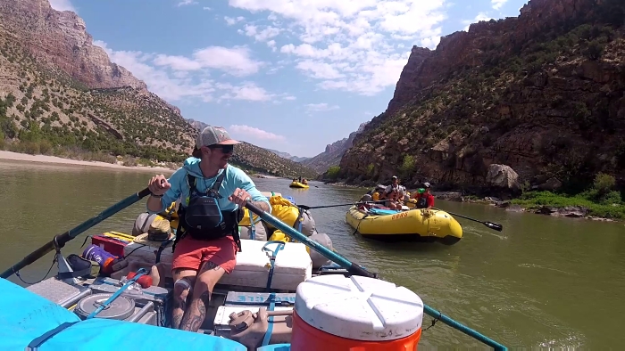 Veteran and Alaskan guide, Logan, rowing the baggage boat